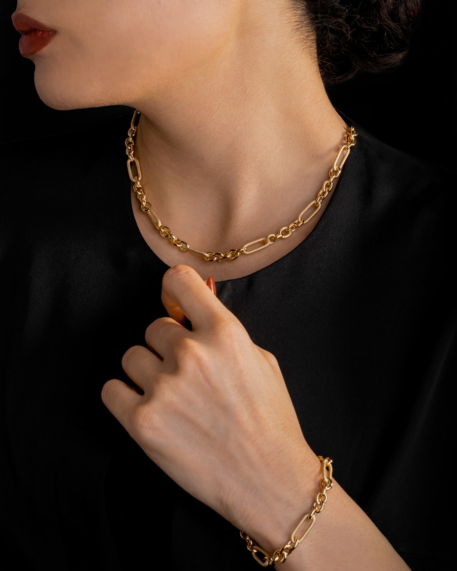 Gold chain and bracelet worn with a black dress